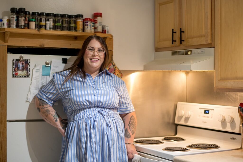 Jacklyn Carroll pictured by a stove in her apartment